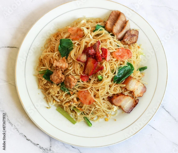 Fototapeta top of view of bihun goreng on white plate. isolated on white.