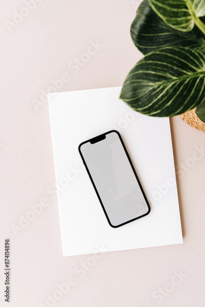 Fototapeta Blank path screen mobile phone with mockup on various notepads on beige background.