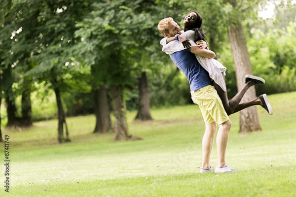 Fototapeta Portrait of a happy couple dancing and hugging in nature outdoor