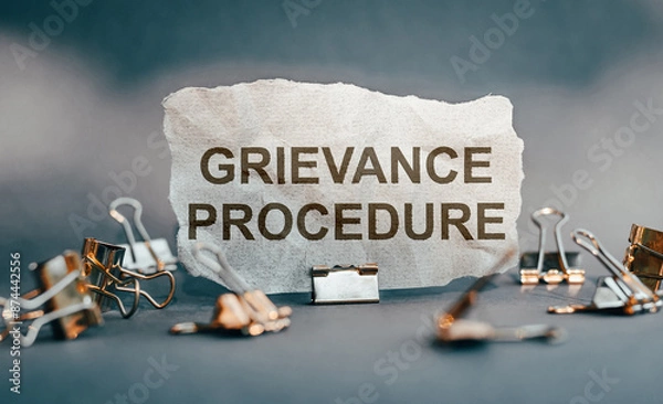 Fototapeta Grievance Procedure Written on Crumpled Paper With Paperclips