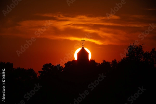 Fototapeta Sunset behind a church