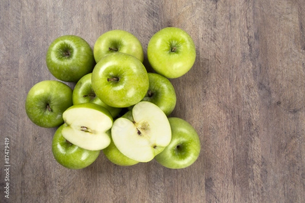Obraz Some green apples on a wooden table
