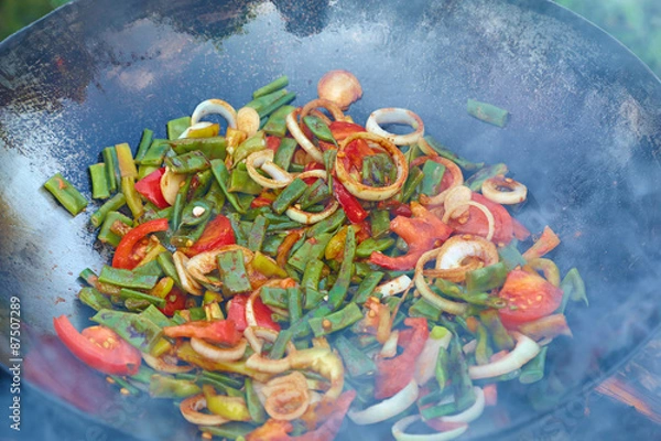Fototapeta Chinese vegetables in wok over an open fire. Fragrant smoke perm
