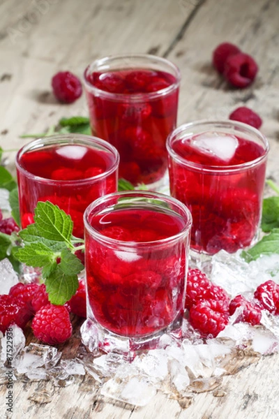 Fototapeta Cold Raspberry drink with mint and ice, selective focus