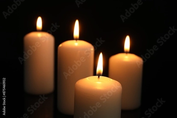 Fototapeta Many burning candles on black background, closeup