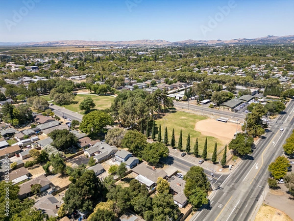 Fototapeta A view over a suburban neighborhood with a large park in Fairfield, California