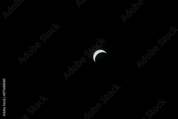 Fototapeta Total eclipse waxing as moon begins to cover the sun