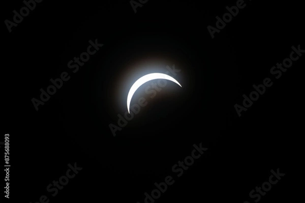 Fototapeta Total eclipse waxing as moon begins to cover the sun