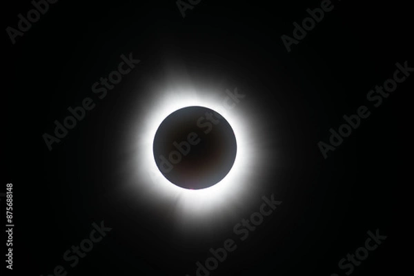 Obraz Light shining from sun around the moon creating a halo effect during the total eclipse