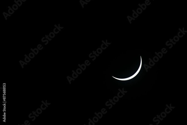 Fototapeta Total eclipse waning as moon begins to uncover the sun