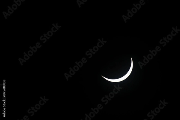 Fototapeta Total eclipse waning as moon begins to uncover the sun