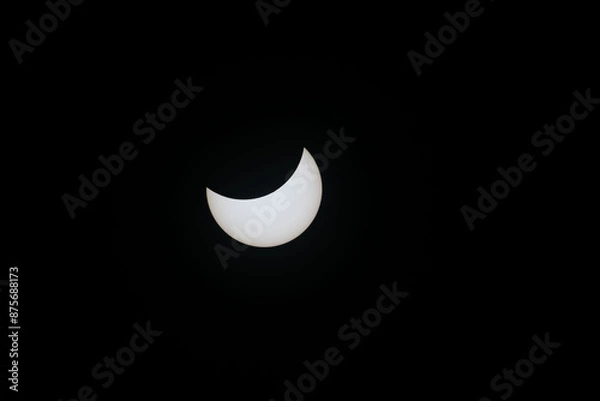 Fototapeta Total eclipse waning as moon begins to uncover the sun