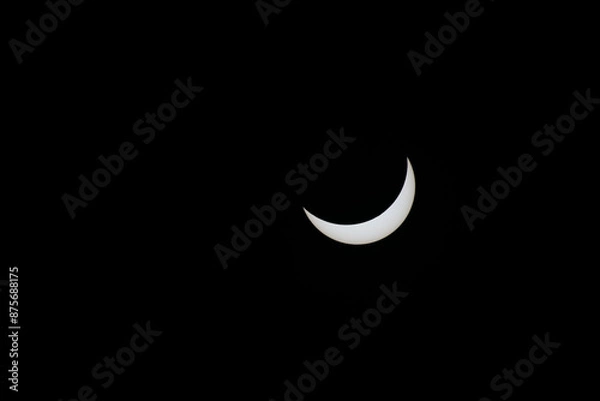 Fototapeta Total eclipse waning as moon begins to uncover the sun