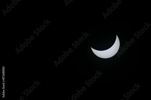 Fototapeta Total eclipse waning as moon begins to uncover the sun