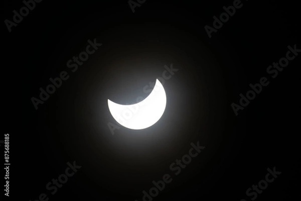 Fototapeta Total eclipse waning as moon begins to uncover the sun