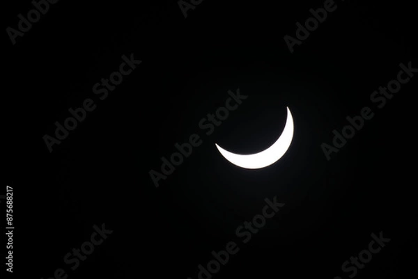 Fototapeta Total eclipse waning as moon begins to uncover the sun