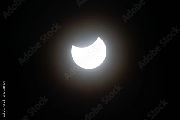 Fototapeta Total eclipse waning as moon begins to uncover the sun
