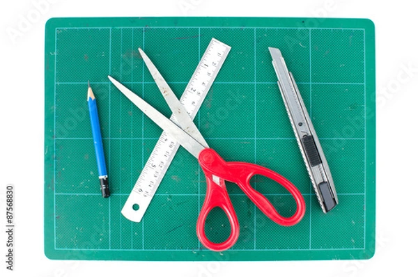 Obraz Green cutting mats with scissors ruler pencil and cuter on white