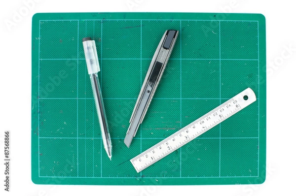 Obraz Green cutting mats with ruler pencil and pen on white background