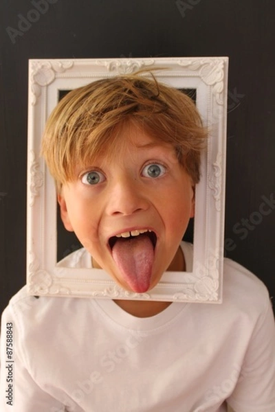 Obraz Young child with his head inside a picture frame
