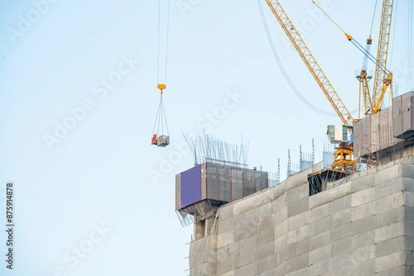 Fototapeta construction worker with crane. Hook cargo crane on the sky background. crane on a construction site