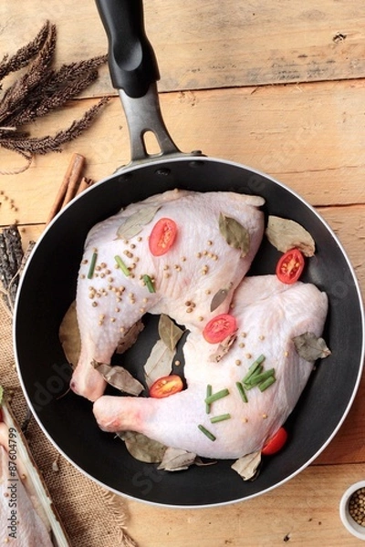 Fototapeta Fresh chicken and tomatoes with spices for cooking