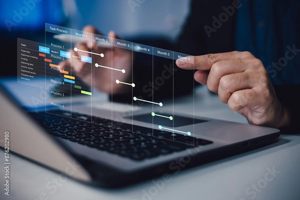 Fototapeta Project manager working and update tasks with milestones progress planning. Businessman using laptop computer plan schedule virtual diagram, business project management concept.