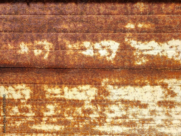 Fototapeta A close-up of an old rusty abandoned garage gate. Industry style, textured wallpaper. Backdrop of grungy warehouse gate. Copy text space