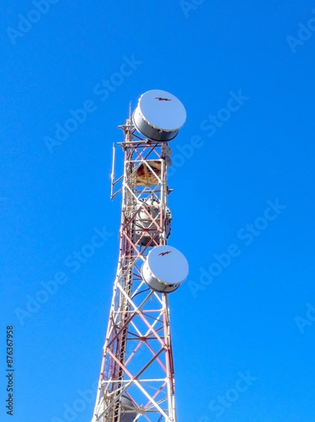 Fototapeta Communication tower with antennas prepared for mobile phones and internet under a clear blue sky