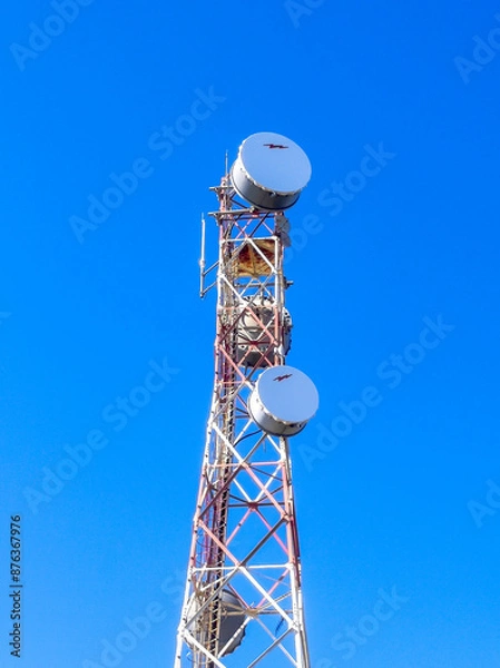 Fototapeta Communication tower with antennas prepared for mobile phones and internet under a clear blue sky