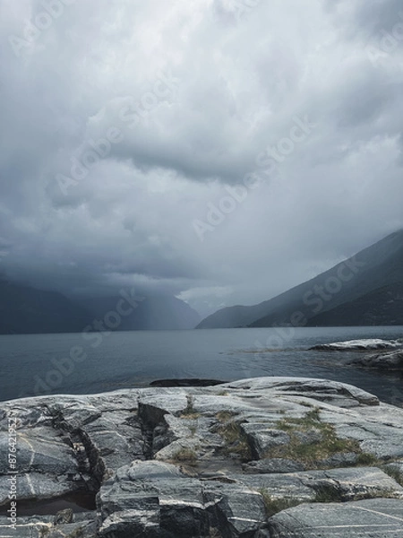 Fototapeta Gloomy Nordic fjords and rocks. Vertical photo with mystic landscape in Norway.