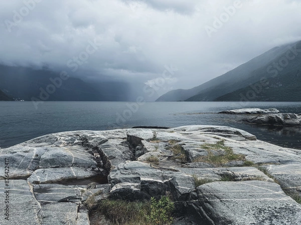 Fototapeta Gloomy Nordic fjords and rocks. Horizontal photo with mystic landscape in Norway.