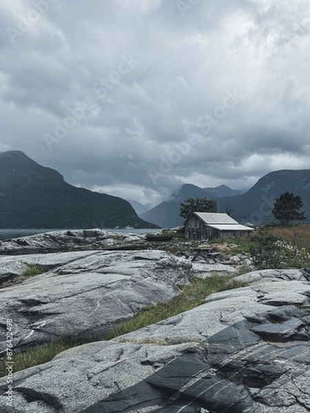 Fototapeta Gloomy Norway hut in front of fjords in July