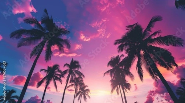 Fototapeta This image presents a breathtaking purple and pink sunset with silhouetted palm trees, capturing the essence of a tropical paradise's colorful and magical evenings.