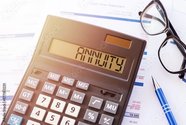 Fototapeta Annuity Concept Displayed on Calculator With Financial Documents in Office Setting