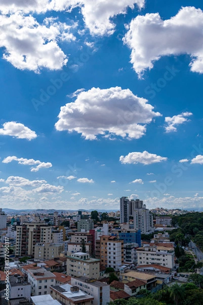 Fototapeta Beautiful blue sky with clouds. Residential buildings. Space for advertising. Vertical.