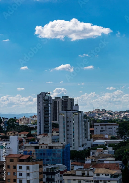 Fototapeta Beautiful blue sky with clouds. Residential buildings. Space for advertising. Vertical.