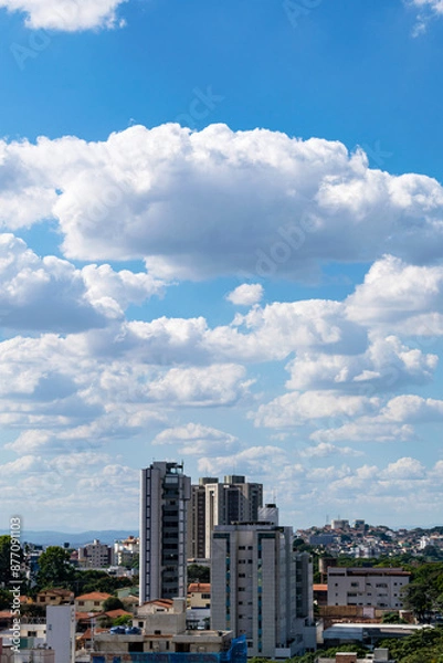 Fototapeta Beautiful blue sky with clouds. Residential buildings. Space for advertising. Vertical.