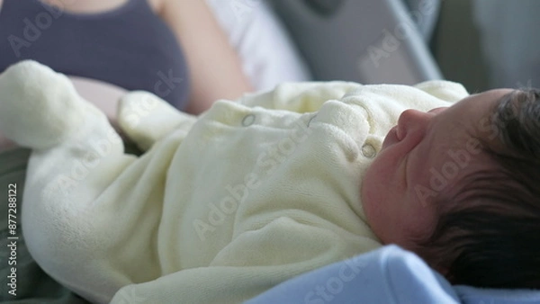 Obraz Side View of a Newborn Baby Resting Comfortably, Highlighting Soft Features and Dark Hair in a Calm, Indoor hospital Environment