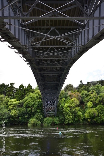 Fototapeta Steel river bridge arch with structure details visible from beneath. Location: Waikato New Zealand
