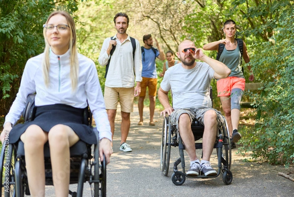 Fototapeta People with mobility disabilities enjoying a day at the park with friends