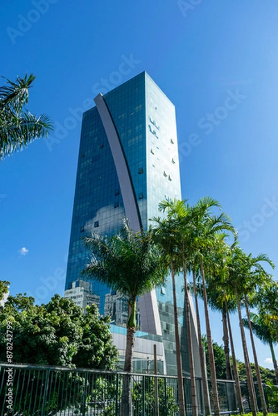 Fototapeta High-luxury building, modern and with a beautiful colorful look. Cloudless blue sky. Space for advertising. Vertical.