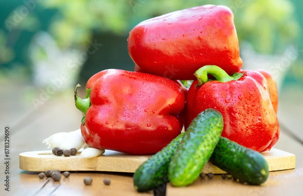 Obraz Fresh vegetables, red pepper, cucumbers and pepper on a wooden table