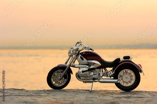 Obraz Motorcycle on the rocks in sunset and golden hours