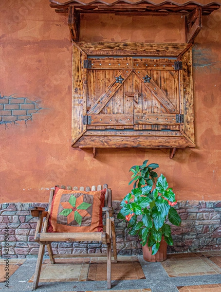 Obraz A wood chair with a old wall