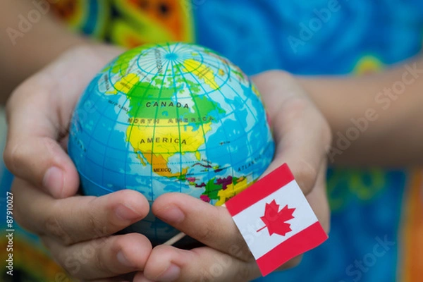 Fototapeta Globe in hand with the Canada flag 