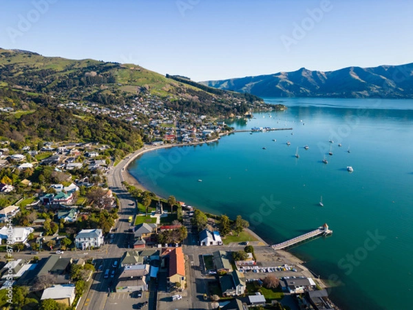 Fototapeta Akaroa, New Zealand: Aerial drone view of the stunning Akaroa idyllic village in the Banks Peninsula in the Christchurch region of Canter bury in New Zealand south island on a sunny day.