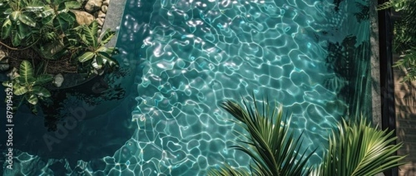 Fototapeta The pool edge and the sparkling water below from a high angle create a unique summer atmosphere and a feeling like a vacation.
