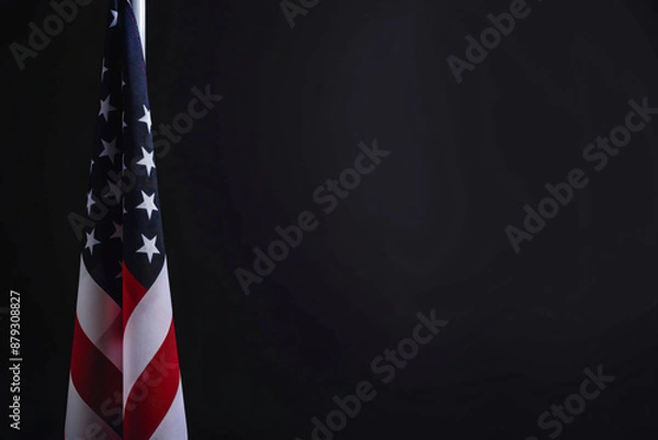 Fototapeta Photo of American flag on a black background with copy space, in a closeup view. USA national symbol for United States holidays or celebrations. Banner design template. Isolated on a studio backdrop.