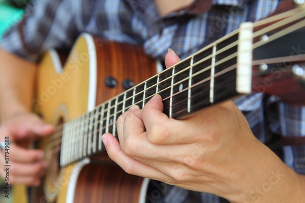 Fototapeta Close up to the hand of guitar player / soft focus